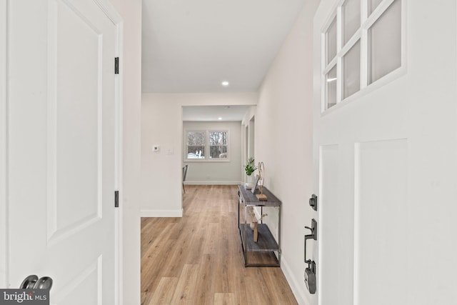 corridor featuring recessed lighting, light wood-type flooring, and baseboards