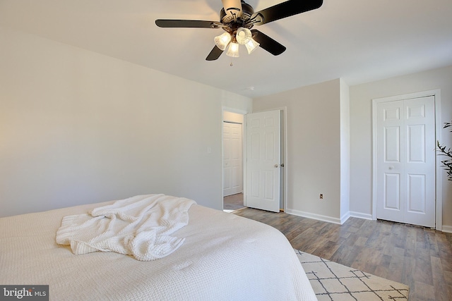 bedroom with a ceiling fan, baseboards, and wood finished floors