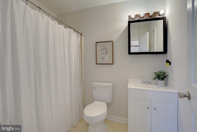 full bathroom with vanity, toilet, and baseboards