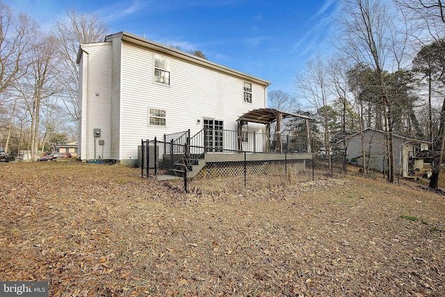 rear view of house featuring a deck