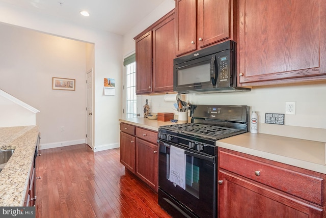 kitchen featuring black appliances, recessed lighting, dark wood-style floors, and baseboards