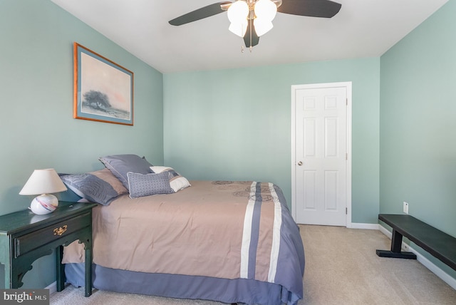 carpeted bedroom with a ceiling fan and baseboards