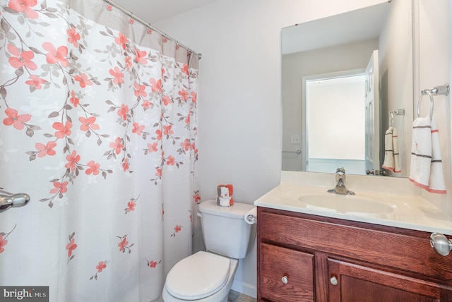 full bathroom with toilet and vanity