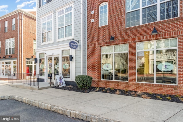 property entrance with french doors and brick siding