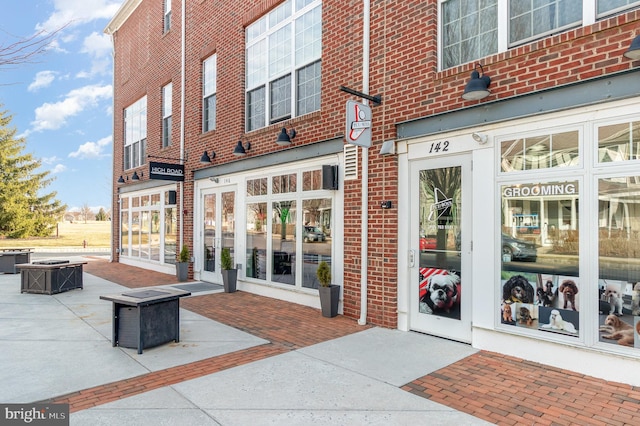 doorway to property featuring brick siding