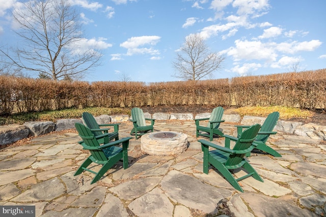 view of patio / terrace with a fire pit and a rural view