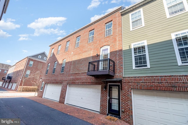 exterior space with a balcony and brick siding