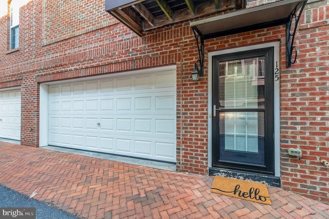 garage with decorative driveway