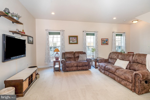 living room featuring light carpet, recessed lighting, and baseboards