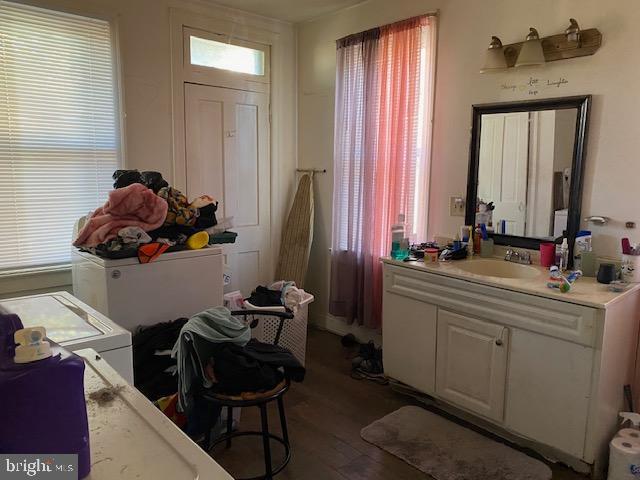 interior space featuring wood finished floors and vanity