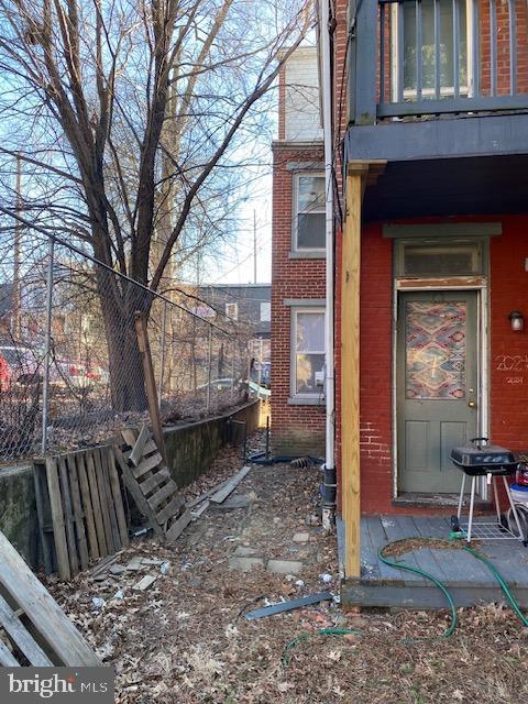 exterior space with brick siding and fence