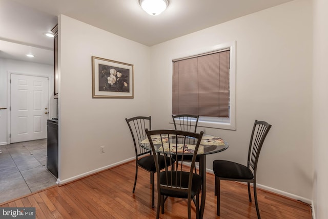 dining space featuring baseboards, recessed lighting, and light wood-style floors