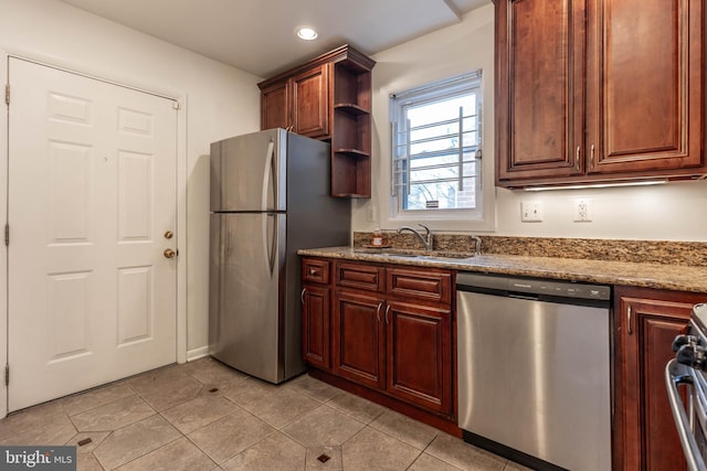 kitchen with light tile patterned floors, stone countertops, stainless steel appliances, a sink, and open shelves