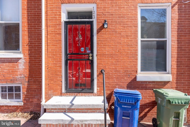 entrance to property with brick siding