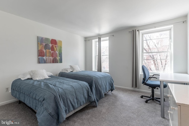 bedroom with baseboards and light colored carpet