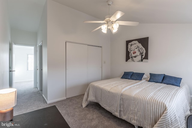 bedroom with carpet floors, lofted ceiling, a closet, ceiling fan, and baseboards