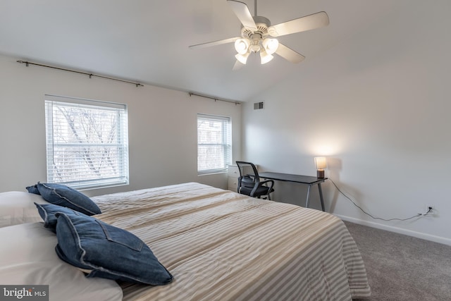 carpeted bedroom featuring baseboards, visible vents, vaulted ceiling, and a ceiling fan