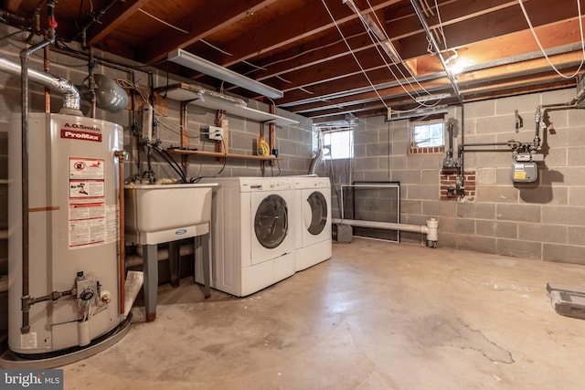 below grade area featuring washing machine and dryer, water heater, and a sink