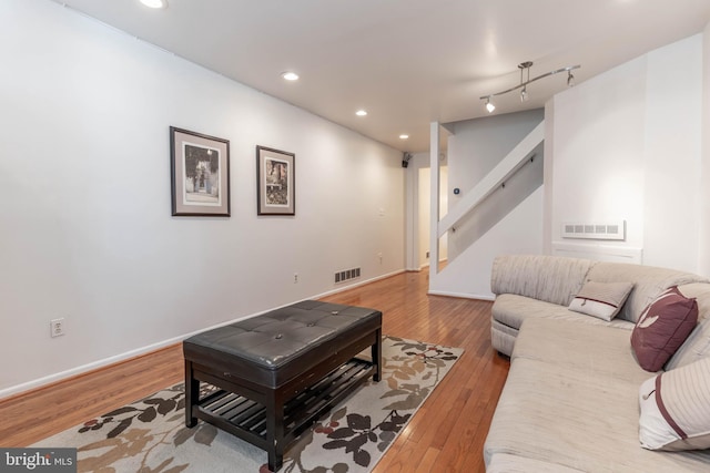 living room featuring visible vents, hardwood / wood-style floors, and recessed lighting