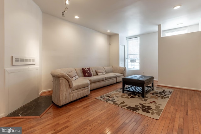 living room featuring recessed lighting, wood-type flooring, a healthy amount of sunlight, and visible vents