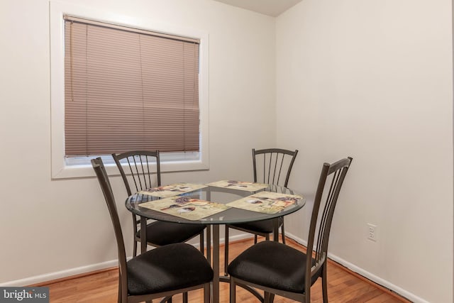 dining room with baseboards and light wood-style floors