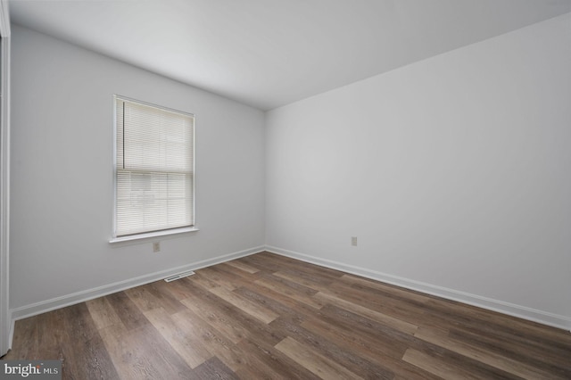 unfurnished room with wood finished floors and baseboards