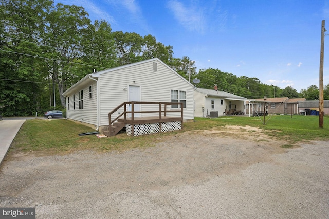 view of front of house with central air condition unit and a front lawn