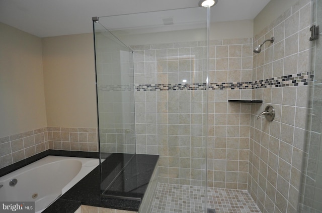 full bathroom featuring a stall shower and a bath