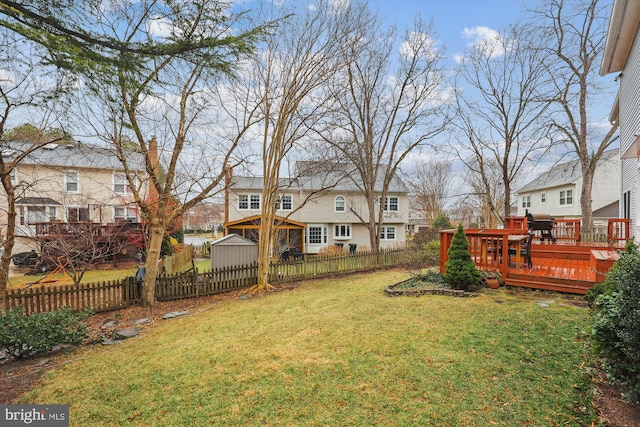 view of yard featuring fence private yard, a residential view, and a wooden deck