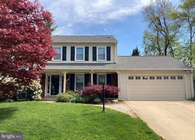 traditional-style house featuring an attached garage, roof with shingles, concrete driveway, and a front yard