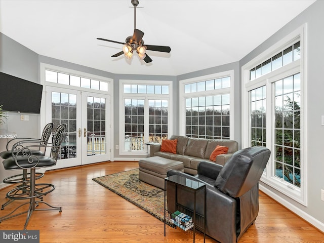 sunroom / solarium with ceiling fan, french doors, and a healthy amount of sunlight