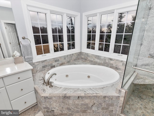 full bath featuring a shower stall, a tub with jets, and vanity