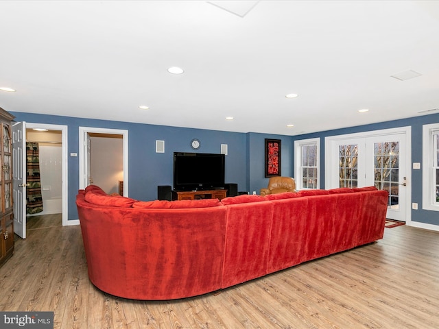 living room with visible vents, baseboards, wood finished floors, and recessed lighting