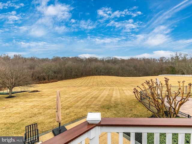 view of yard with fence and a view of trees