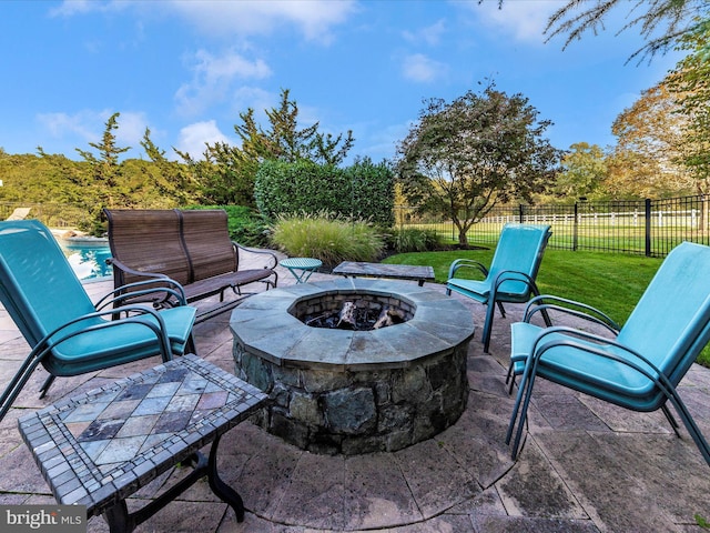 view of patio with an outdoor fire pit, fence, and a fenced in pool