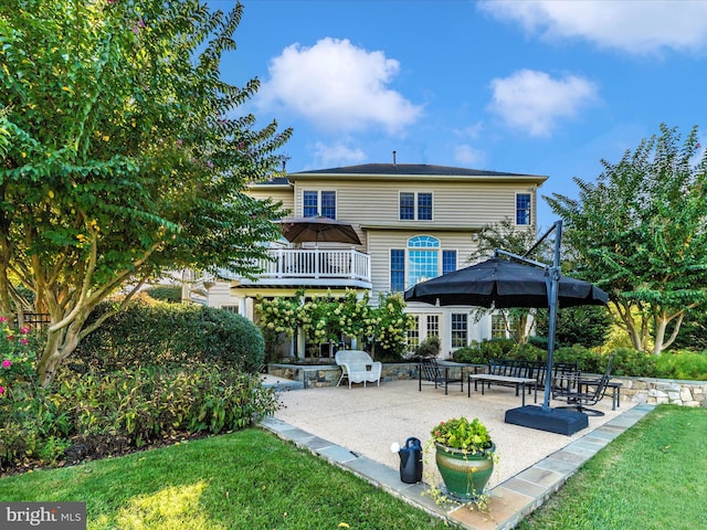 back of property featuring a lawn and a patio area