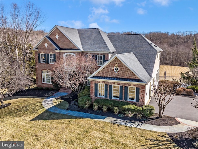 view of front of property with brick siding and a front yard