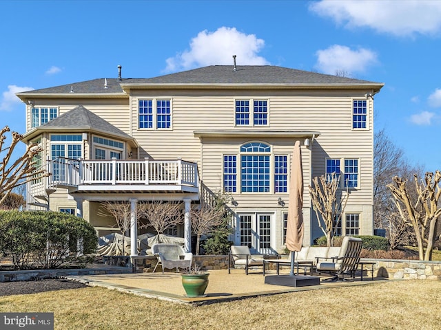 rear view of property featuring a yard, french doors, and a patio