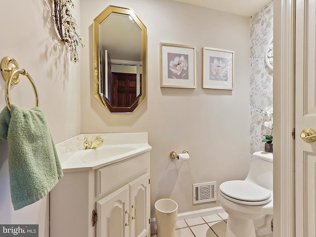 bathroom featuring visible vents, toilet, vanity, tile patterned flooring, and baseboards