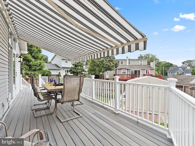 deck with a residential view and outdoor dining space