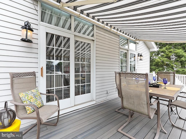 wooden terrace featuring outdoor dining area