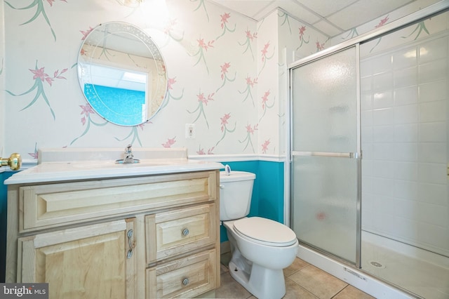 bathroom with tile patterned floors, a shower stall, wallpapered walls, and toilet