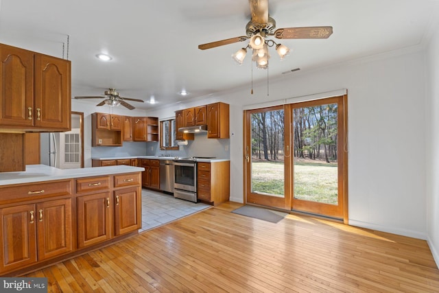 kitchen with open shelves, visible vents, appliances with stainless steel finishes, light wood-type flooring, and under cabinet range hood