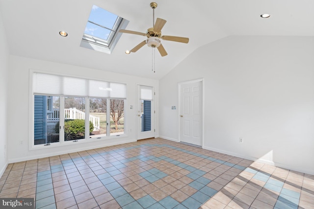 spare room featuring ceiling fan, vaulted ceiling with skylight, tile patterned flooring, and recessed lighting