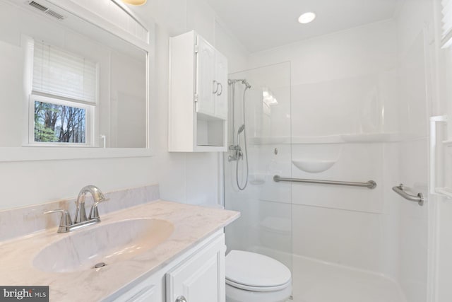 bathroom with toilet, vanity, visible vents, ornamental molding, and walk in shower