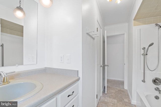 full bathroom featuring stone finish flooring, bathtub / shower combination, vanity, and baseboards