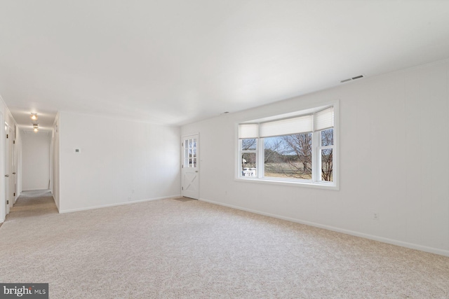 empty room with light carpet, baseboards, and visible vents