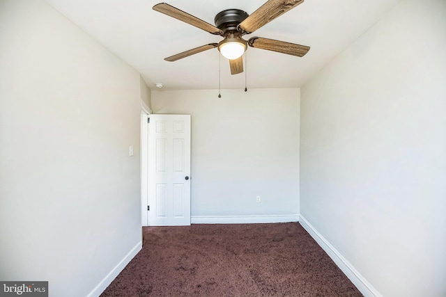 carpeted empty room featuring a ceiling fan and baseboards