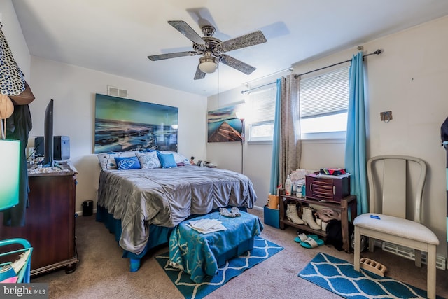 carpeted bedroom with visible vents and a ceiling fan