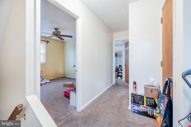 hallway with carpet and baseboards